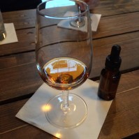 Dram of whisky with dropper for water.